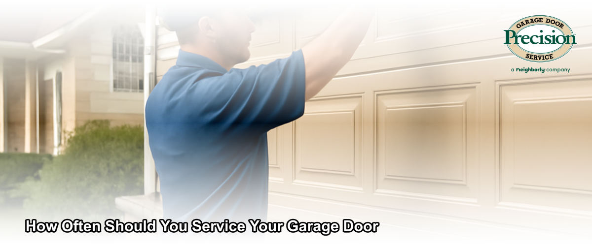 Technician performing a professional garage door maintenance inspection on a residential home in South Jersey