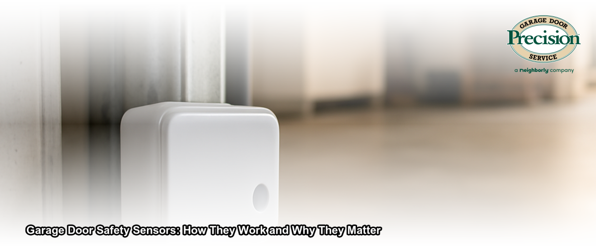 Close-up of garage door safety sensor mounted on a door track in a residential garage in New Jersey