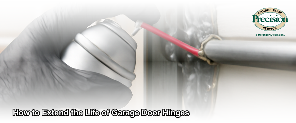 Close-up of a steel garage door hinge being lubricated during routine maintenance