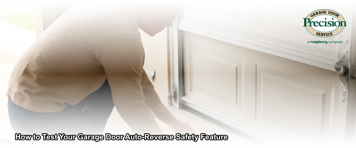 Homeowner testing garage door auto-reverse safety feature with a wooden board on the garage floor in a residential New Jersey home